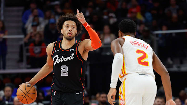 Nov 14, 2023; Detroit, Michigan, USA;  Detroit Pistons guard Cade Cunningham (2) dribbles defended by Atlanta Hawks guard Trent Forrest (2) at Little Caesars Arena. Mandatory Credit: Rick Osentoski-Imagn Images