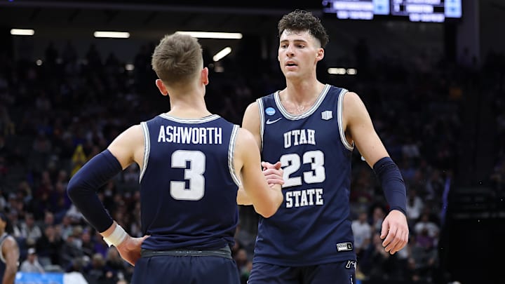 Mar 16, 2023; Sacramento, CA, USA; Utah State Aggies guard Steven Ashworth (3) greets forward Taylor Funk (23) during the second half at Golden 1 Center. Mandatory Credit: Kelley L Cox-Imagn Images