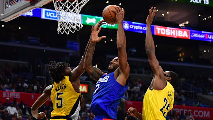 Mar 25, 2024; Los Angeles, California, USA; Los Angeles Clippers forward Kawhi Leonard (2) shoots against Indiana Pacers forward Jarace Walker (5) and forward Jalen Smith (25) during the second half at Crypto.com Arena. Mandatory Credit: Gary A. Vasquez-USA TODAY Sports