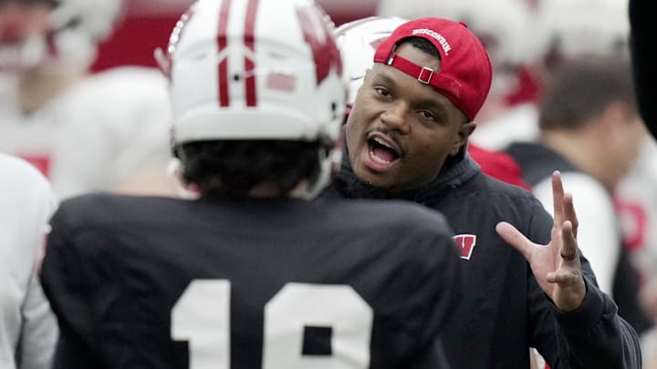 Wisconsin wide receivers coach Jordan Reid talks to quarterback Danny O’Neil during spring football practice Thursday, April 3, 2025 in Madison, Wisconsin