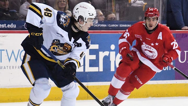 Erie Otters defenseman Matthew Schaeffer, left, works near Sault Ste. Marie Greyhounds forward Marco Mignosa at Erie Insurance Arena in Erie on Nov. 22, 2024.