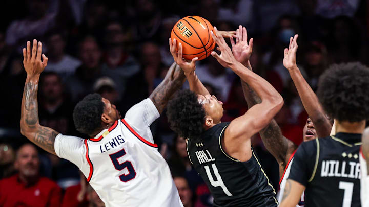 Jan 11, 2025; Tucson, Arizona, USA; Arizona Wildcats guard KJ Lewis (5) and guard Jaden Bradley (0) both block UCF Knights guard-forward Keyshawn Hall (4) from a basket during the second half of the game at McKale Center. Mandatory Credit: Aryanna Frank-Imagn Images