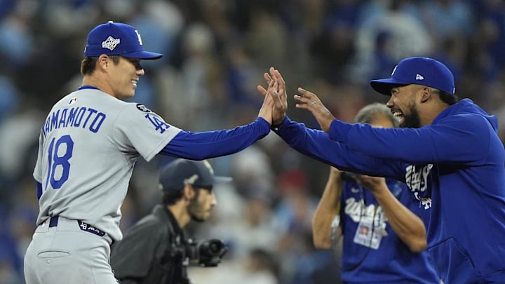 Oct 25, 2025; Toronto, Ontario, CAN; Los Angeles Dodgers pitcher Yoshinobu Yamamoto (18) celebrates with right fielder Teoscar Hernandez (37) after defeating the Toronto Blue Jays in game two of the 2025 MLB World Series at Rogers Centre. Mandatory Credit: John E. Sokolowski-Imagn Images Oct 25, 2025; Toronto, Ontario, CAN; Los Angeles Dodgers pitcher Yoshinobu Yamamoto (18) celebrates with right fielder Teoscar Hernandez (37) after defeating the Toronto Blue Jays in game two of the 2025 MLB World Series at Rogers Centre. Mandatory Credit: John E. Sokolowski-Imagn Images