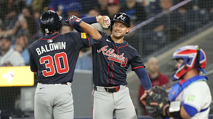 Apr 16, 2025; Toronto, Ontario, CAN; Atlanta Braves right fielder Jarred Kelenic (24) congratulates right fielder Drake Baldwin (30) on his solo home run as Toronto Blue Jays catcher Alejandro Kirk (30) looks on during the ninth inning at Rogers Centre. Mandatory Credit: John E. Sokolowski-Imagn Images