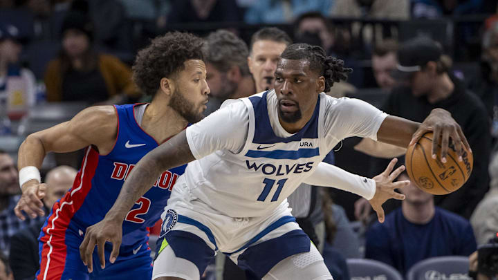 Mar 27, 2024; Minneapolis, Minnesota, USA; Minnesota Timberwolves center Naz Reid (11) backs towards the basket and keeps the ball away from Detroit Pistons guard Cade Cunningham (2) in the second half at Target Center. Mandatory Credit: Jesse Johnson-Imagn Images