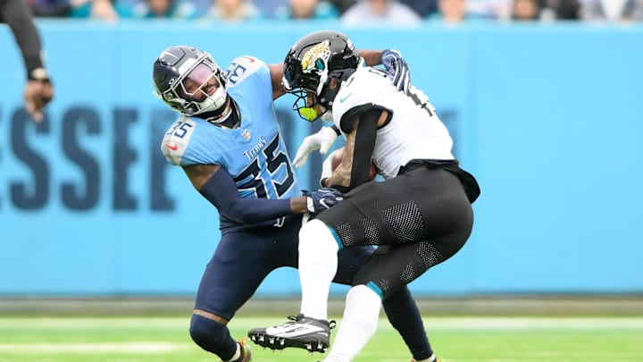 Dec 8, 2024; Nashville, Tennessee, USA;  Tennessee Titans defensive back Daryle Worley (35) tackles Jacksonville Jaguars tight end Evan Engram (17) after a made catch during the second half at Nissan Stadium. Mandatory Credit: Steve Roberts-Imagn Images