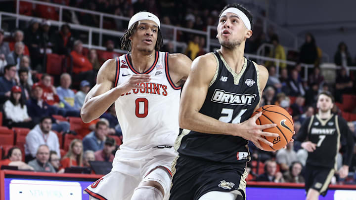 Dec 11, 2024; Queens, New York, USA; Bryant University Bulldogs guard Rafael Pinzon (24) looks to drive past St. John's Red Storm guard Aaron Scott (0) in the first half at Carnesecca Arena. Mandatory Credit: Wendell Cruz-Imagn Images Dec 11, 2024; Queens, New York, USA; Bryant University Bulldogs guard Rafael Pinzon (24) looks to drive past St. John's Red Storm guard Aaron Scott (0) in the first half at Carnesecca Arena. Mandatory Credit: Wendell Cruz-Imagn Images