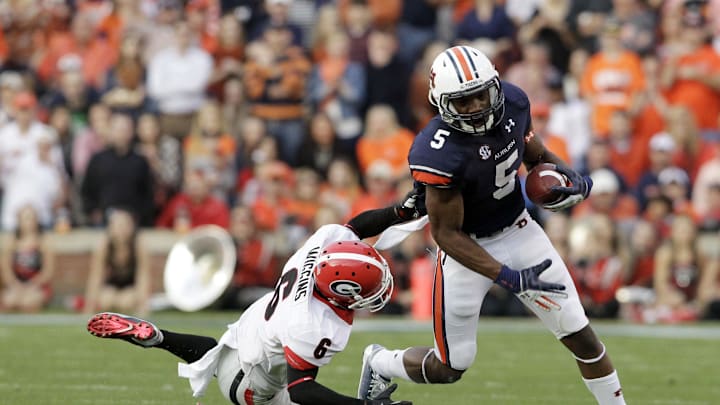 Nov 16, 2013; Auburn, AL, USA; Auburn Tigers receiver Ricardo Louis (5) avoids Georgia Bulldogs cornerback Shaq Wiggins (6) during the first half at Jordan Hare Stadium.  The Tigers beat the Bulldogs 43-38.  Mandatory Credit: John Reed-Imagn Images