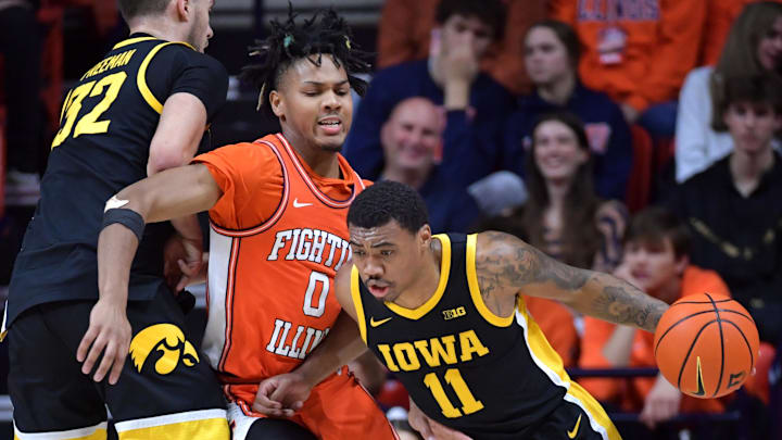 Feb 24, 2024; Champaign, Illinois, USA;  Iowa Hawkeyes guard Tony Perkins (11) moves the ball around