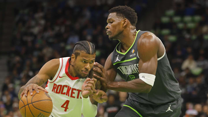 Nov 26, 2024; Minneapolis, Minnesota, USA; Houston Rockets guard Jalen Green (4) drives against Minnesota Timberwolves guard Anthony Edwards (5) in the first quarter at Target Center. Mandatory Credit: Bruce Kluckhohn-Imagn Images