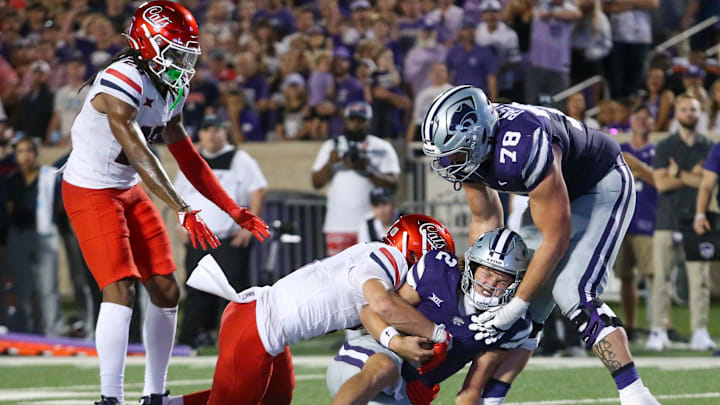 Sep 13, 2024; Manhattan, Kansas, USA; Kansas State Wildcats quarterback Avery Johnson (2) is tackled short of the goal line by Arizona Wildcats defensive back Gunner Maldonado (9) during the third quarter at Bill Snyder Family Football Stadium. Mandatory Credit: Scott Sewell-Imagn Images