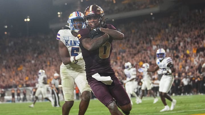 Arizona State receiver Jordyn Tyson (0) catches the game-winning touchdown past Kansas safety O.J. Burroughs (5) at Mountain America Stadium on Oct. 5, 2024.