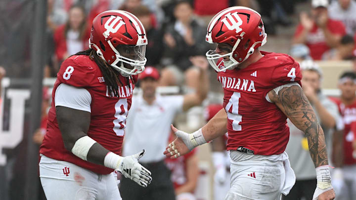 Sep 28, 2024; Bloomington, Indiana, USA; Indiana Hoosiers defensive lineman CJ West (8) and linebacker Aiden Fisher (4) celebrate after a defensive stop against the Maryland Terrapins during the first half at Memorial Stadium. Mandatory Credit: Robert Goddin-Imagn Images