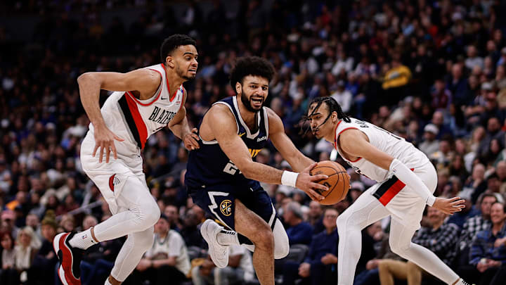 Feb 12, 2025; Denver, Colorado, USA; Denver Nuggets guard Jamal Murray (27) controls the ball under pressure from Portland Trail Blazers guard Rayan Rupert (21) and guard Dalano Banton (5) in the third quarter at Ball Arena. Mandatory Credit: Isaiah J. Downing-Imagn Images Feb 12, 2025; Denver, Colorado, USA; Denver Nuggets guard Jamal Murray (27) controls the ball under pressure from Portland Trail Blazers guard Rayan Rupert (21) and guard Dalano Banton (5) in the third quarter at Ball Arena. Mandatory Credit: Isaiah J. Downing-Imagn Images