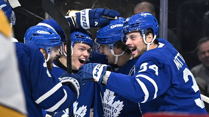 Oct 14, 2025; Toronto, Ontario, CAN;  Toronto Maple Leafs forward Auston Matthews (34) celebrates with forwards Easton Cowan (53) and Matthew Knies (23) and defenseman Oliver Ekman-Larsson (95) after scoring a goal against the Nashville Predators in the third period at Scotiabank Arena. Mandatory Credit: Dan Hamilton-Imagn Images