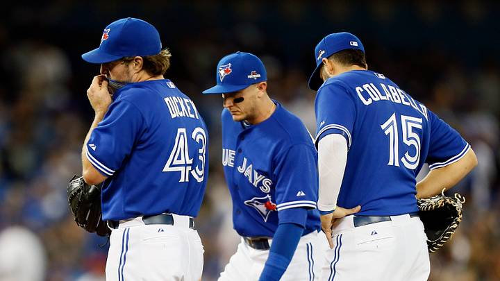 Oct 20, 2015; Toronto, Ontario, CAN; Toronto Blue Jays starting pitcher R.A. Dickey (43) and shortstop Troy Tulowitzki (middle) and first baseman Chris Colabello (15) react during the second inning against the Kansas City Royals in game four of the ALCS at Rogers Centre. Mandatory Credit: John E. Sokolowski-USA TODAY Sports
