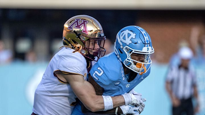 Sep 16, 2023; Chapel Hill, North Carolina, USA; North Carolina Tar Heels wide receiver Gavin Blackwell (2) catches the ball as Minnesota Golden Gophers defensive back Aidan Gousby (7) defends in the third quarter at Kenan Memorial Stadium. 