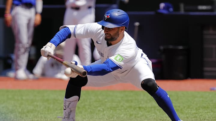 Toronto Blue Jays center fielder Kevin Kiermaier (39) lays down a sacrifice bunt to advance Toronto Blue Jays right fielder Addison Barger (not pictured) during the second inning against tjr Texas Rangers at Rogers Centre in 2024. Toronto Blue Jays center fielder Kevin Kiermaier (39) lays down a sacrifice bunt to advance Toronto Blue Jays right fielder Addison Barger (not pictured) during the second inning against tjr Texas Rangers at Rogers Centre in 2024.