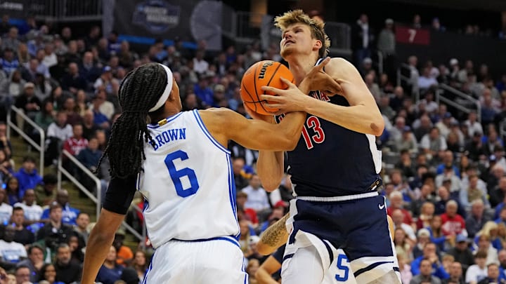 Mar 27, 2025; Newark, NJ, USA; Arizona Wildcats forward Henri Veesaar (13) grabs a rebound against Duke basketball forward Maliq Brown (6) during the first half during an East Regional semifinal of the 2025 NCAA tournament at Prudential Center