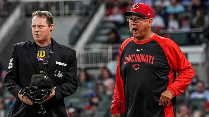 Sep 24, 2026; Cumberland, Georgia, USA; Cincinnati Reds manager Terry Francona (77) discusses a play against the Atlanta Braves with umpire Junior Valentine (25) during the third inning at Truist Park. Mandatory Credit: Dale Zanine-Imagn Images