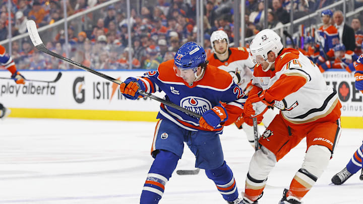 Mar 28, 2026; Edmonton, Alberta, CAN; Edmonton Oilers forward Matt Savoie (22) and Anaheim Ducks defensemen John Carlson (74) battle for a loose puck during the third period at Rogers Place. Mandatory Credit: Perry Nelson-Imagn Images