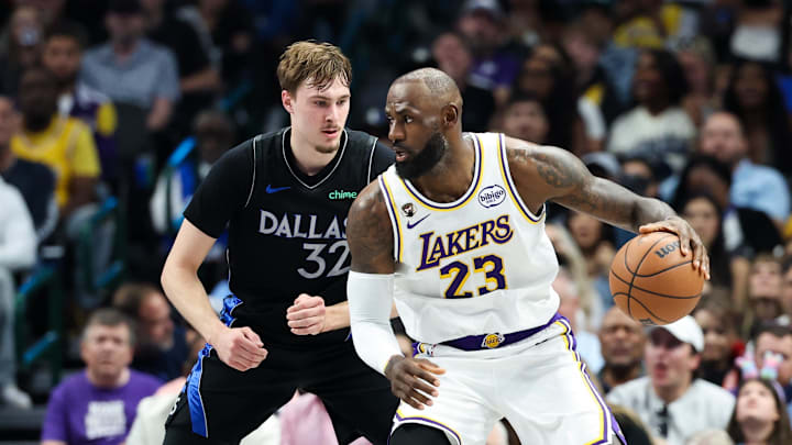 Apr 5, 2026; Dallas, Texas, USA;  Los Angeles Lakers forward LeBron James (23) controls the ball as  Dallas Mavericks forward Cooper Flagg (32) defends during the first half at American Airlines Center. Mandatory Credit: Kevin Jairaj-Imagn Images