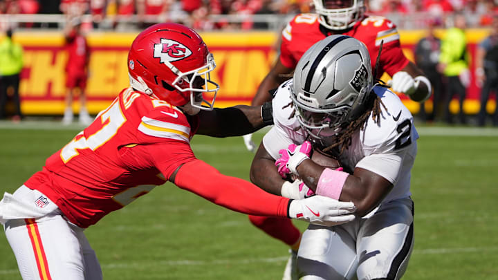 Oct 19, 2025; Kansas City, Missouri, USA; Kansas City Chiefs defensive back Chamarri Conner (27) tackles Las Vegas Raiders running back Ashton Jeanty (2) during the third quarter of the game at GEHA Field at Arrowhead Stadium. Mandatory Credit: Denny Medley-Imagn Images | Denny Medley-Imagn Images