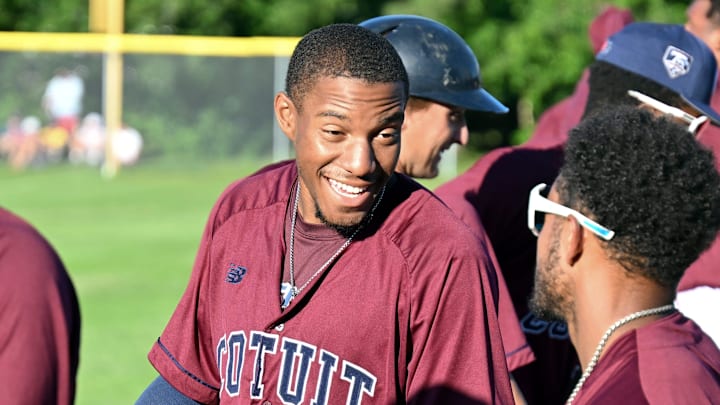 Chandler Simpson shares a moment with his Cotuit teammate Victor Scott II during their game with Yarmouth-Dennis.