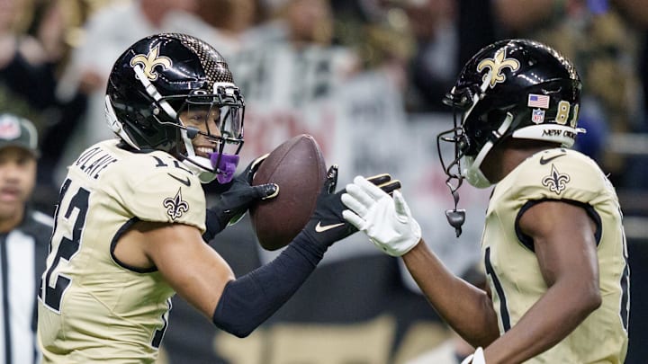 Dec 21, 2025; New Orleans, Louisiana, USA;  New Orleans Saints wide receiver Chris Olave (12) celebrates a touchdown against the New York Jets with wide receiver Kevin Austin Jr. (81) during the fourth quarter at Caesars Superdome. Mandatory Credit: Matthew Hinton-Imagn Images