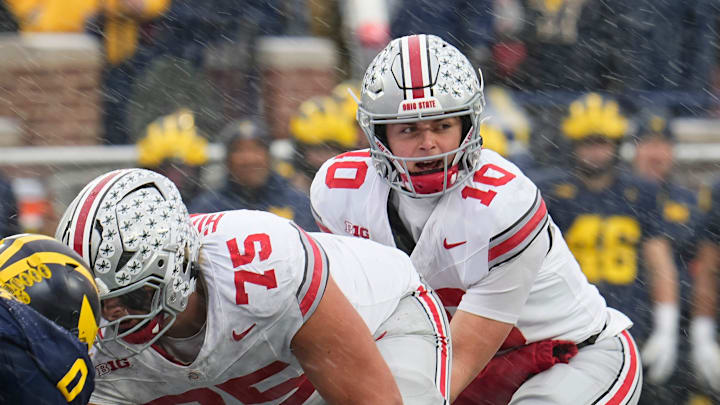 Ohio State Buckeyes quarterback Julian Sayin (10) takes a snap from offensive lineman Carson Hinzman (75) during the NCAA football game against the Michigan Wolverines at Michigan Stadium in Ann Arbor, Mich. on Nov. 29, 2025. Ohio State won 27-9.