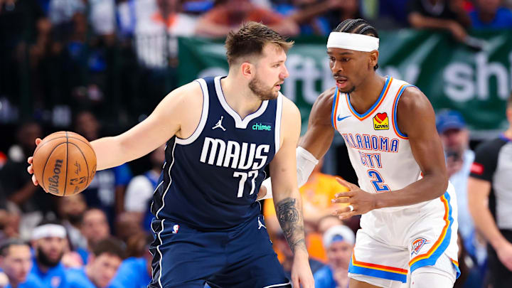 May 11, 2024; Dallas, Texas, USA; Dallas Mavericks guard Luka Doncic (77) controls the ball as Oklahoma City Thunder guard Shai Gilgeous-Alexander (2) defends during the second half during game three of the second round for the 2024 NBA playoffs at American Airlines Center. Mandatory Credit: Kevin Jairaj-Imagn Images