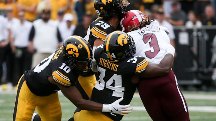 Iowa’s Nick Jackson (10), Jay Higgins (34) and Sebastian Castro (29) tackle Troy’s running back Damien Taylor (3) Saturday, Sept. 14, 2024 at Kinnick Stadium in Iowa City, Iowa.