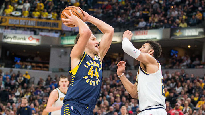 Mar 24, 2019; Indianapolis, IN, USA; Indiana Pacers forward Bojan Bogdanovic (44) shoots the ball while Denver Nuggets guard Jamal Murray (27) defends in the second half at Bankers Life Fieldhouse. Mandatory Credit: Trevor Ruszkowski-Imagn Images