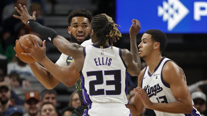 Mar 1, 2024; Minneapolis, Minnesota, USA; Minnesota Timberwolves forward Karl-Anthony Towns (32) looks to get away from the defensive pressure of Sacramento Kings guard Keon Ellis (23) and forward Keegan Murray (13) in the first quarter at Target Center. Mandatory Credit: Bruce Kluckhohn-Imagn Images