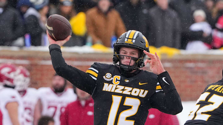 Nov 30, 2024; Columbia, Missouri, USA; Missouri Tigers quarterback Brady Cook (12) throws a pass against the Arkansas Razorbacks during the first half at Faurot Field at Memorial Stadium. Mandatory Credit: Denny Medley-Imagn Images