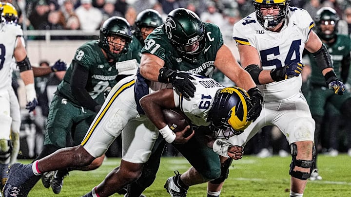 Michigan State defensive lineman Alex VanSumeren (91) tackles Michigan quarterback Bryce Underwood (19) during the second half at Spartan Stadium in East Lansing on Saturday, October 25, 2025. Michigan State defensive lineman Alex VanSumeren (91) tackles Michigan quarterback Bryce Underwood (19) during the second half at Spartan Stadium in East Lansing on Saturday, October 25, 2025.