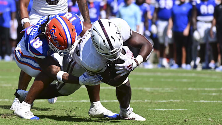Mississippi State Bulldogs running back Johnnie Daniels runs the ball against Florida Gators defensive back Bryce Thornton.