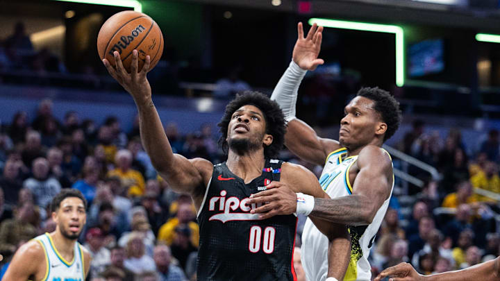 Nov 27, 2024; Indianapolis, Indiana, USA; Portland Trail Blazers guard Scoot Henderson (00) shoots the ball while Indiana Pacers guard Bennedict Mathurin (00) defends in the second half at Gainbridge Fieldhouse. Mandatory Credit: Trevor Ruszkowski-Imagn Images Nov 27, 2024; Indianapolis, Indiana, USA; Portland Trail Blazers guard Scoot Henderson (00) shoots the ball while Indiana Pacers guard Bennedict Mathurin (00) defends in the second half at Gainbridge Fieldhouse. Mandatory Credit: Trevor Ruszkowski-Imagn Images