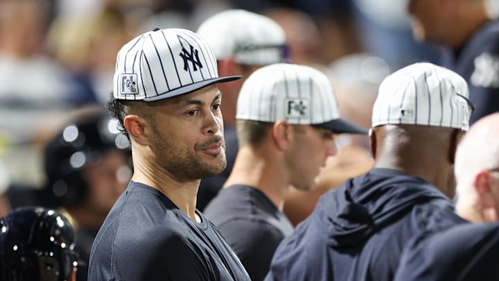 Stanton looks on from the dugout. 