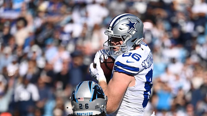Nov 19, 2023; Charlotte, North Carolina, USA;  Dallas Cowboys tight end Luke Schoonmaker (86) catches a touchdown catch as Carolina Panthers cornerback Donte Jackson (26) defends in the first quarter at Bank of America Stadium. Mandatory Credit: Bob Donnan-Imagn Images