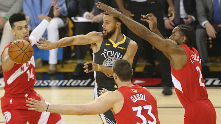 Jun 7, 2019; Oakland, CA, USA; Golden State Warriors guard Stephen Curry (30) passes the ball while Toronto Raptors forward Kawhi Leonard (2) and guard Danny Green (14) defend during the first quarter game four of the 2019 NBA Finals at Oracle Arena. Mandatory Credit: Cary Edmondson-Imagn Images