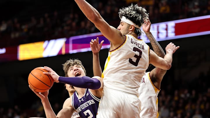 Feb 25, 2025; Minneapolis, Minnesota, USA; Northwestern Wildcats guard Ty Berry (3) shoots the ball as Minnesota Golden Gophers forward Dawson Garcia (3) defends during the second half at Williams Arena. Mandatory Credit: Matt Krohn-Imagn Images