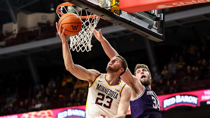 Feb 25, 2025; Minneapolis, Minnesota, USA; Minnesota Golden Gophers forward Parker Fox (23) shoots as Northwestern Wildcats center Matthew Nicholson (34) defends during the first half at Williams Arena. Mandatory Credit: Matt Krohn-Imagn Images