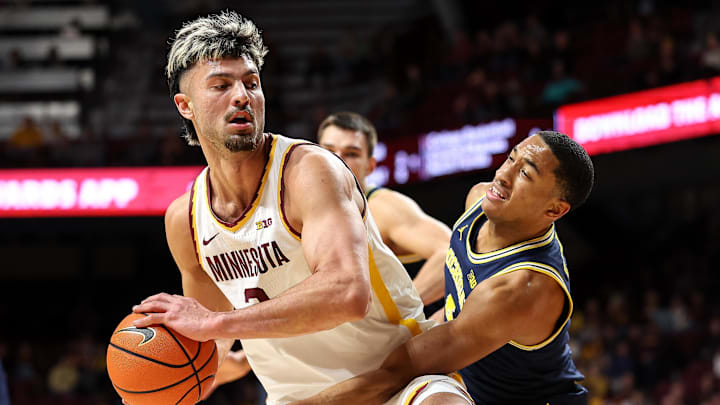 Jan 16, 2025; Minneapolis, Minnesota, USA; Minnesota Golden Gophers forward Dawson Garcia (3) works around Michigan Wolverines guard Nimari Burnett (4) during the first half at Williams Arena. Mandatory Credit: Matt Krohn-Imagn Images