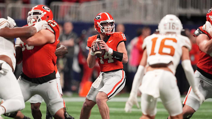 Dec 7, 2024; Atlanta, GA, USA; Georgia Bulldogs quarterback Gunner Stockton (14) drops back to pass against the Texas Longhorns during the second half in the 2024 SEC Championship game at Mercedes-Benz Stadium. Mandatory Credit: Dale Zanine-Imagn Images Dec 7, 2024; Atlanta, GA, USA; Georgia Bulldogs quarterback Gunner Stockton (14) drops back to pass against the Texas Longhorns during the second half in the 2024 SEC Championship game at Mercedes-Benz Stadium. Mandatory Credit: Dale Zanine-Imagn Images