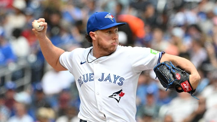 Former Toronto Blue Jays pitcher Nate Pearson throws a pitch wearing a white jersey and blue hat. Former Toronto Blue Jays pitcher Nate Pearson throws a pitch wearing a white jersey and blue hat.