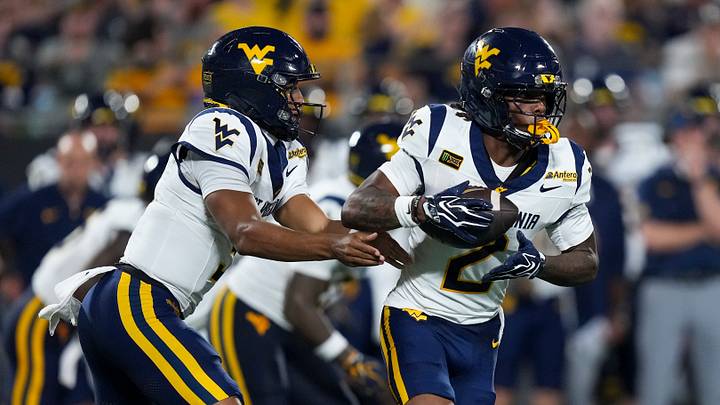 Sep 19, 2026; Charlotte, North Carolina, USA; West Virginia Mountaineers quarterback Michael Hawkins Jr. (3) hands off to wide receiver DJ Epps (2) during the second quarter against the Virginia Cavaliers at Bank of America Stadium. Mandatory Credit: Jim Dedmon-Imagn Images Sep 19, 2026; Charlotte, North Carolina, USA; West Virginia Mountaineers quarterback Michael Hawkins Jr. (3) hands off to wide receiver DJ Epps (2) during the second quarter against the Virginia Cavaliers at Bank of America Stadium. Mandatory Credit: Jim Dedmon-Imagn Images