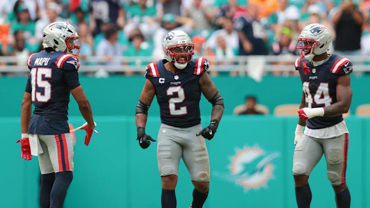 Sep 14, 2025; Miami Gardens, Florida, USA; New England Patriots linebacker Harold Landry III (2) celebrates with linebacker Marte Mapu (15) and linebacker K'Lavon Chaisson (44) after sacking Miami Dolphins quarterback Tua Tagovailoa (not pictured) during the fourth quarter at Hard Rock Stadium. Mandatory Credit: Sam Navarro-Imagn Images