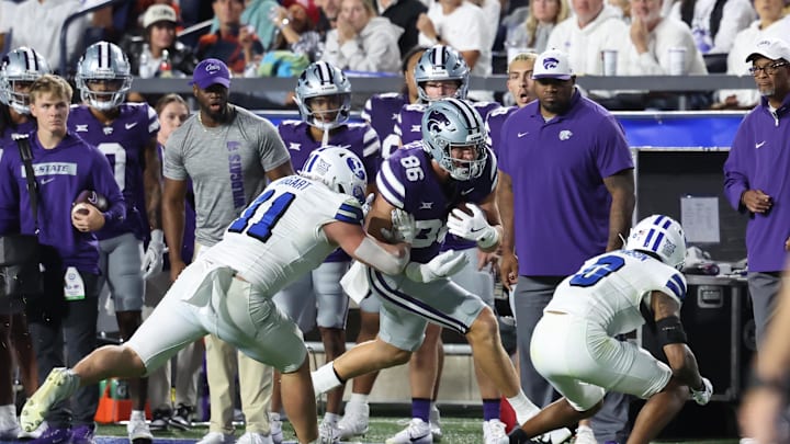 Sep 21, 2024; Provo, Utah, USA; Kansas State Wildcats tight end Garrett Oakley (86) runs after a catch and is tackled by Brigham Young Cougars linebacker Harrison Taggart (11) and cornerback Jakob Robinson (0) during the third quarter at LaVell Edwards Stadium. Mandatory Credit: Rob Gray-Imagn Images Sep 21, 2024; Provo, Utah, USA; Kansas State Wildcats tight end Garrett Oakley (86) runs after a catch and is tackled by Brigham Young Cougars linebacker Harrison Taggart (11) and cornerback Jakob Robinson (0) during the third quarter at LaVell Edwards Stadium. Mandatory Credit: Rob Gray-Imagn Images
