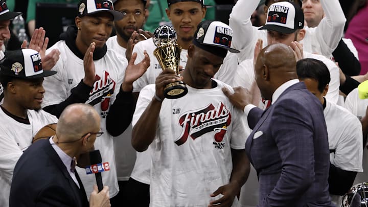 Jimmy Butler raises Eastern Conference Finals MVP trophy after the Miami Heat upset the Boston Celtics.
